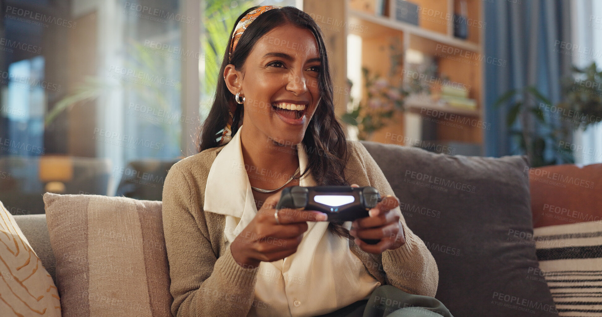 Buy stock photo Indian woman, home and excited with video game in sofa at living room for fun and esports challenge . Female person, happy and smile with joystick or controller on couch for entertainment on break