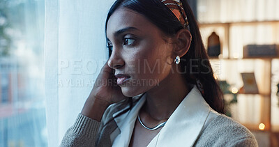 Buy stock photo Indian woman, worry and window in home with thinking or concern, storm with travel restrictions for work. Female teacher, glass or house with reflection for winter or weather, fear for climate change