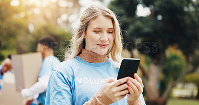 Buy stock photo Phone, volunteer and woman in park for charity event, community service and inventory. Volunteering, ngo outreach and person on smartphone for social media, internet and online website outdoors