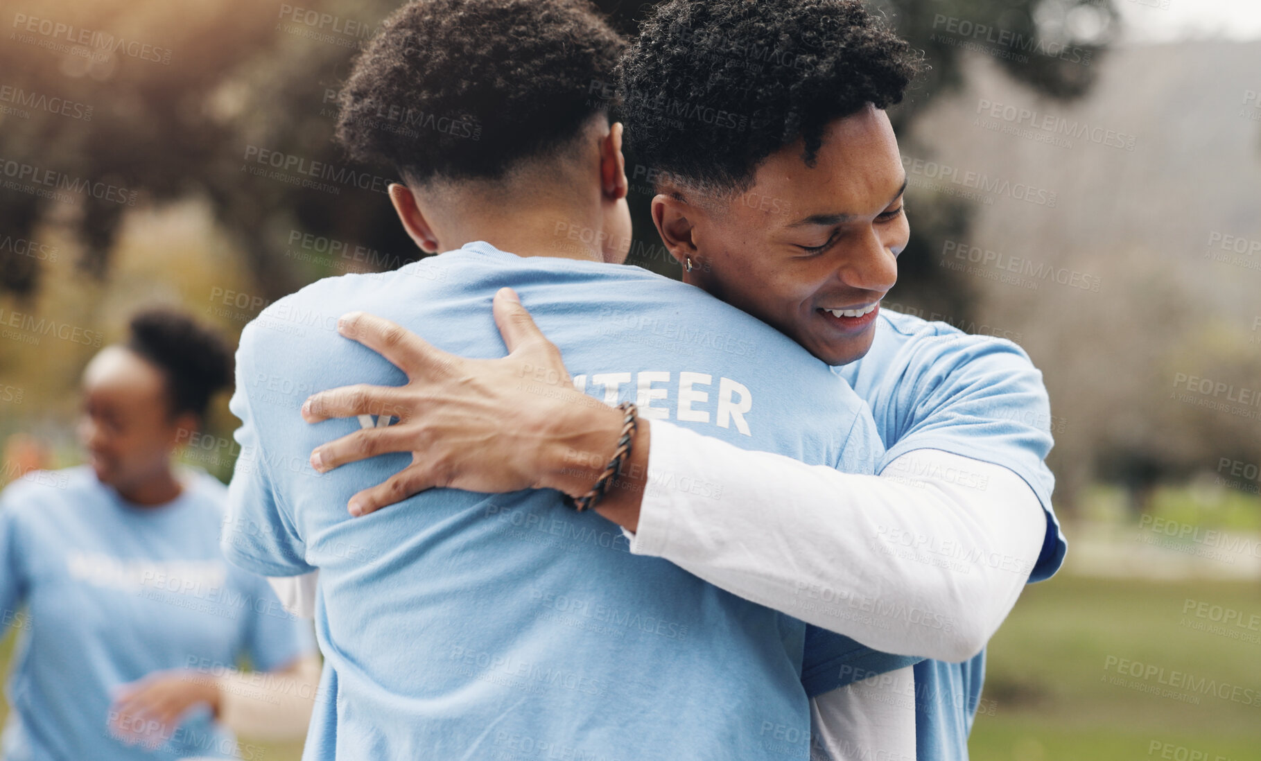 Buy stock photo Men, volunteer and friends hug in park together for solidarity, support or sustainability at green ngo. Gratitude, nature and people in embrace for teamwork, community care or social responsibility