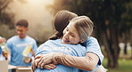 Women, volunteer and friends hug in park together for solidarity, support or sustainability at green ngo. Gratitude, nature and people in embrace for teamwork, community care or social responsibility