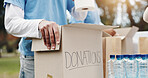 Boxes, charity and volunteer in event, hands and people in ngo with kindness, donations and service. Outdoor, team and social responsibility for poverty, nonprofit and gift for help in community