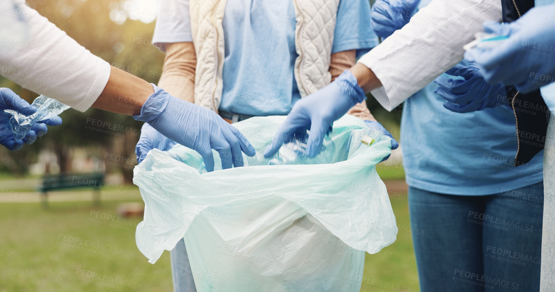 Buy stock photo Cleaning, volunteer and people in park with garbage collection for sustainability, plastic and ngo project. Solidarity, trash and hand with bag for charity, community care and social responsibility