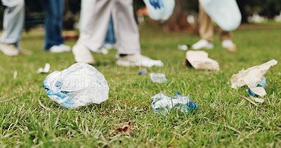 Buy stock photo Cleaning, volunteer and people on grass with trash collection for sustainability, plastic and ngo project. Solidarity, garbage and hand with bag for charity, community care and social responsibility