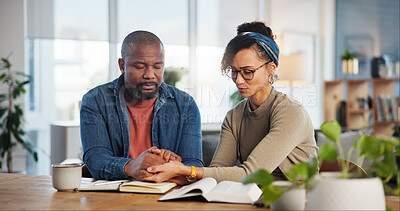 Buy stock photo Couple, home and praying with bible for religion or spiritual guidance, belief and knowledge. Relationship, people and Christian with scripture or verse on holy book for worship, faith and gratitude