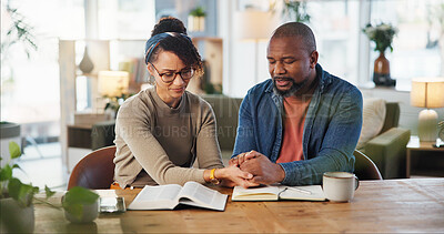 Buy stock photo Couple, holding hands and praying with bible for religion or spiritual guidance, belief and knowledge. Relationship, home and Christian with scripture on holy book for worship, gratitude and faith