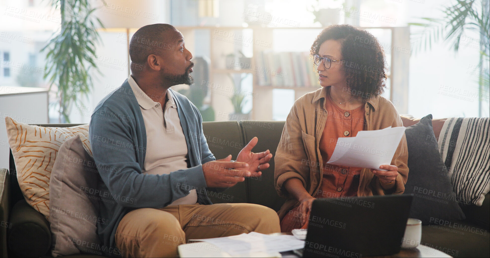 Buy stock photo House, documents and senior couple with laptop, conversation and financial planning. Conflict, man and woman with paperwork, budget or retirement fund with internet, connection and computer in lounge