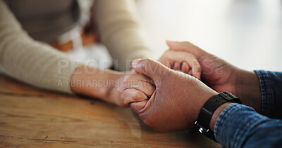 Buy stock photo Holding hands, couple and faith on table, home and praying for love, compassion and communication. House, trust and people with belief, Christian and respect for relationship, commitment and worship