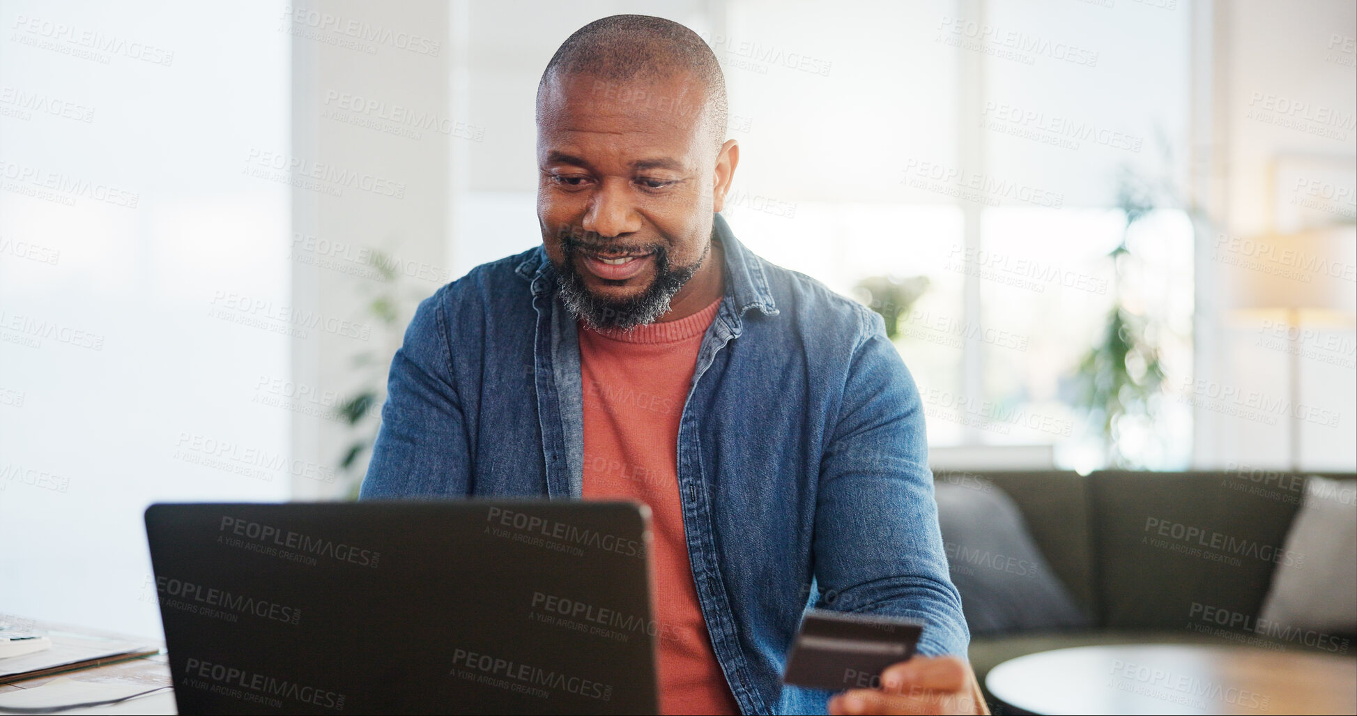 Buy stock photo Black man, home and happy on laptop with debit card for online shopping, ecommerce and purchase. Male person, internet banking and buying or payment with credit verification, check and approval