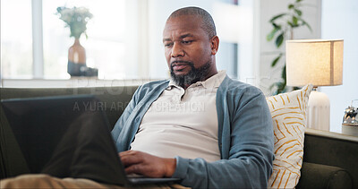 Buy stock photo Laptop, relax and black man on sofa in home for research on holiday planning with flight ticket. Computer, living room and African male person reading online review for hotel booking with travel.