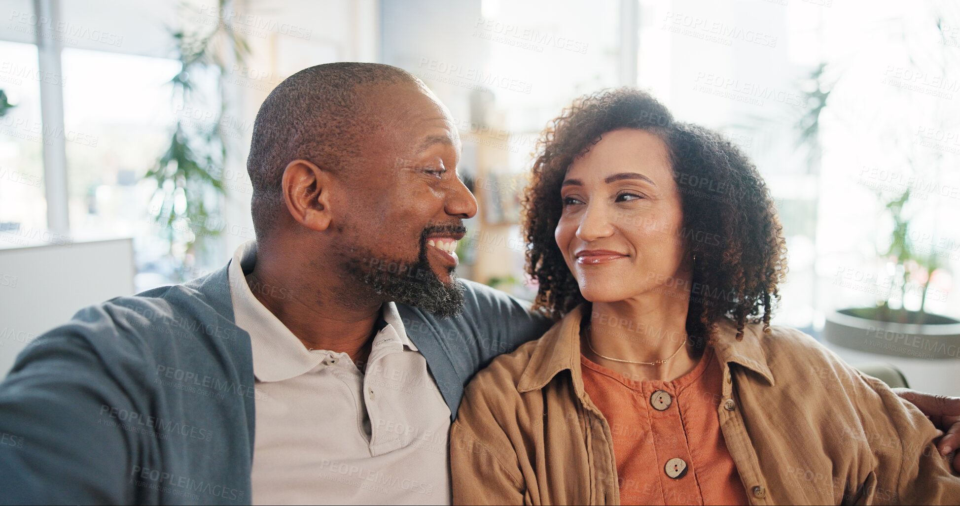 Buy stock photo Mature couple, selfie and smile on couch in home with hug, bonding and love with photography in lounge. Man, woman and happy on sofa for profile picture, memory or post on social network in apartment