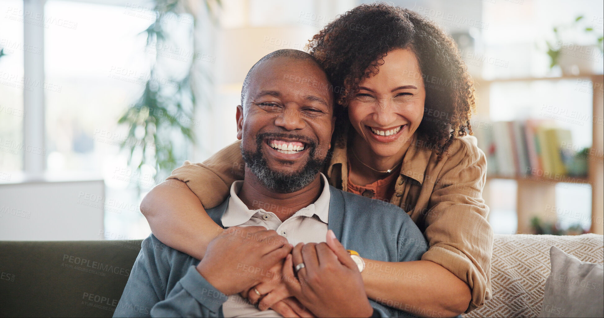 Buy stock photo Couple, laughing and hug portrait in home for romance, support and commitment in marriage with love. Interracial people, security and embrace in living room of house for loyalty, comfort or affection