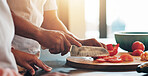 Cooking, closeup and hands of couple with knife in house kitchen for food, meal prep and nutrition. Ingredients, teamwork and people in home cutting vegetables or tomatoes for dinner, lunch or brunch