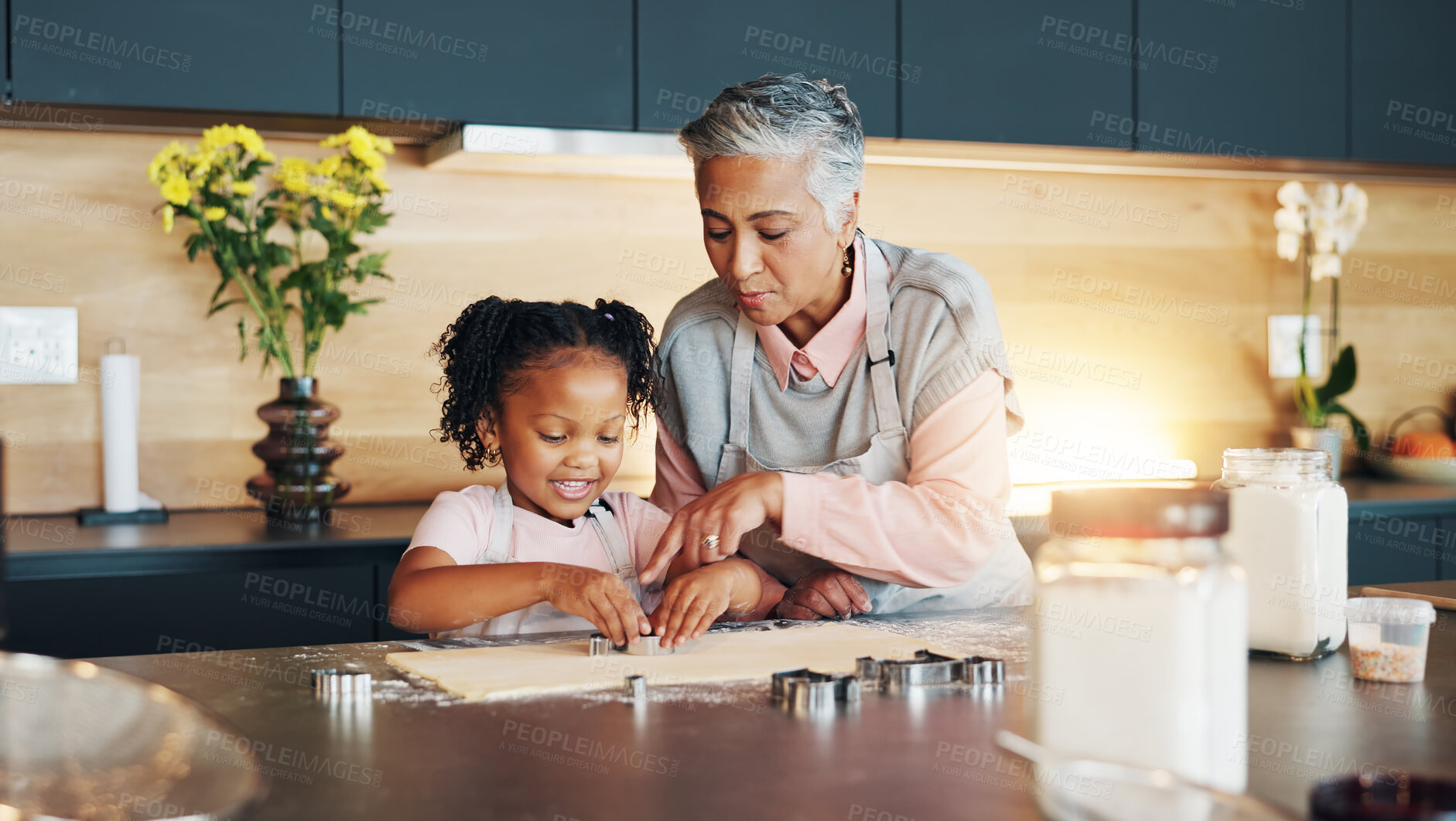 Buy stock photo Grandma, little girl and baking with cookie cutter on table in kitchen for learning, teaching or making dough at home. Grandmother, child or junior baker with shapes for dessert or recipe at house