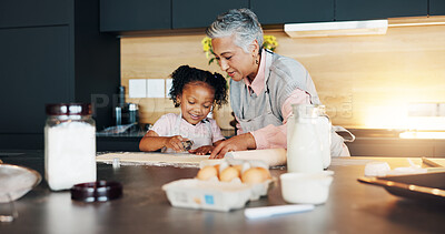 Buy stock photo Grandmother, little girl and baking with cookie cutter on table in kitchen for learning, teaching or making dough at home. Grandma, child or junior baker with shapes for dessert or recipe at house