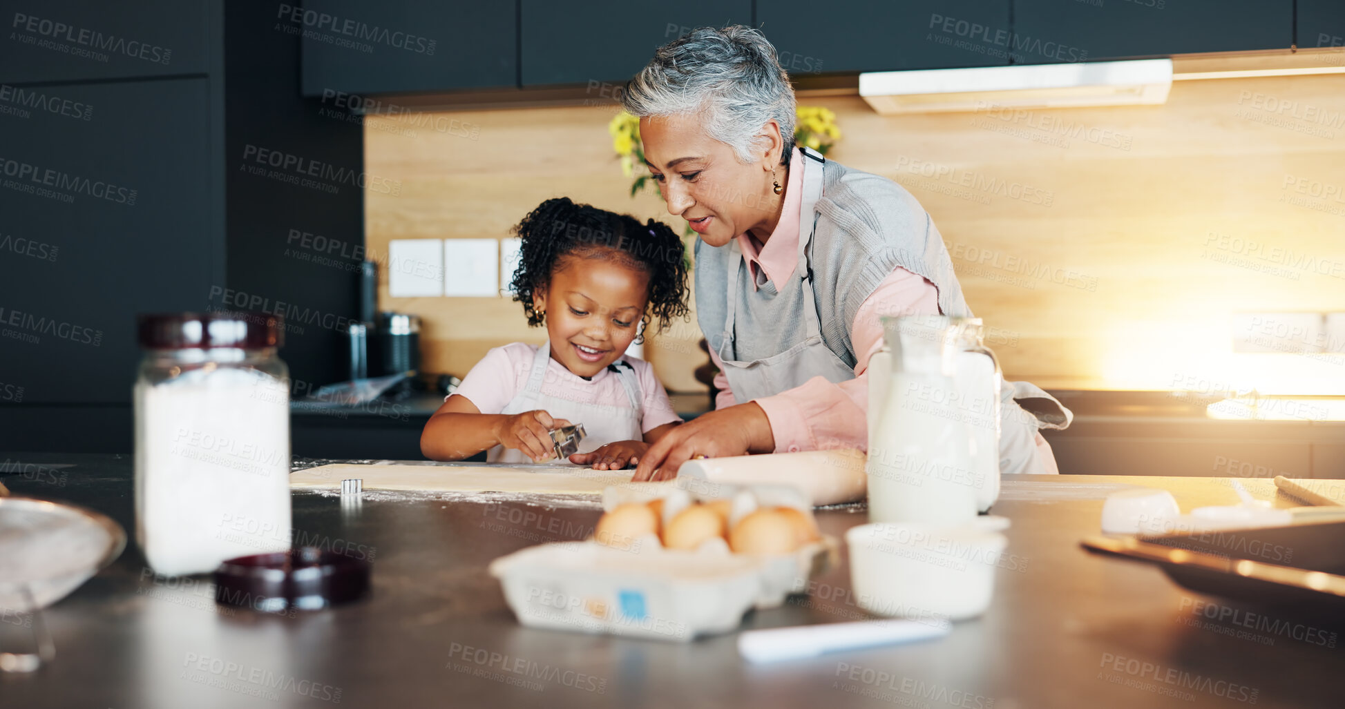 Buy stock photo Grandmother, little girl and baking with cookie cutter on table in kitchen for learning, teaching or making dough at home. Grandma, child or junior baker with shapes for dessert or recipe at house