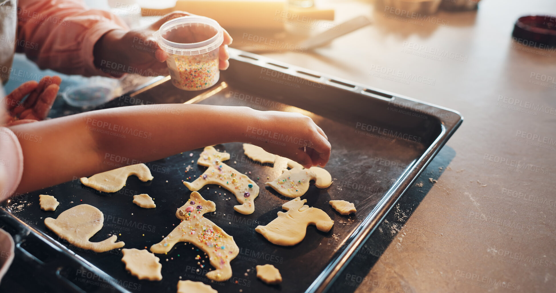 Buy stock photo Cookies, hands and baking with tray for sprinkles, food and child in kitchen with snack recipe. Dessert, kid and childhood development for decoration, learning and cooking with handmade biscuits