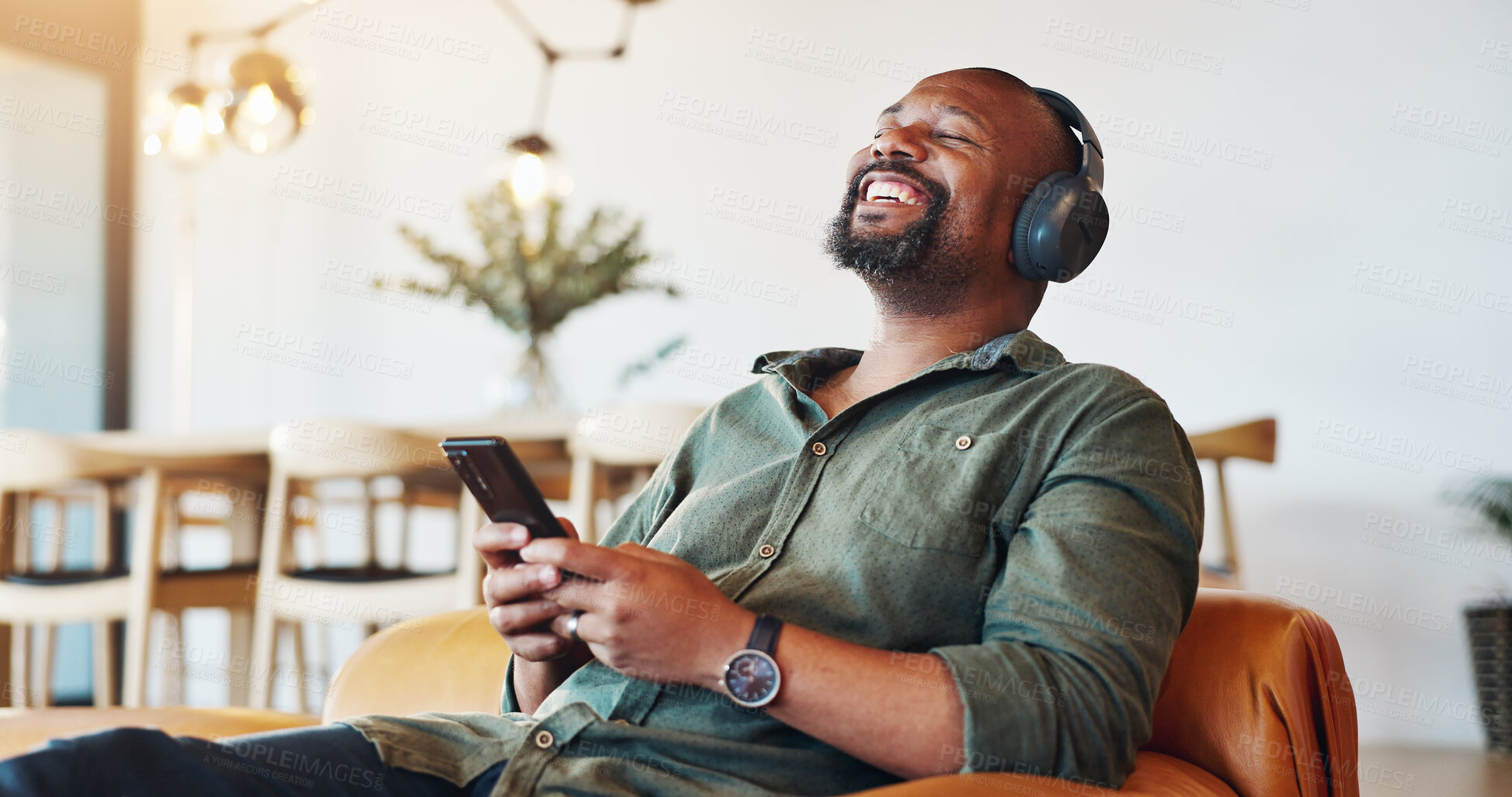 Buy stock photo Headphones, phone and black man relax in home with happiness for online music, playlist or album review. Smile, audio tech and African male person with cellphone for streaming radio, podcast or video