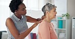 Woman, physiotherapist and patient with neck pain for injury or medical consultation at clinic. Female person, orthopedic and senior client with sore spine, ache or muscle tension at private practice