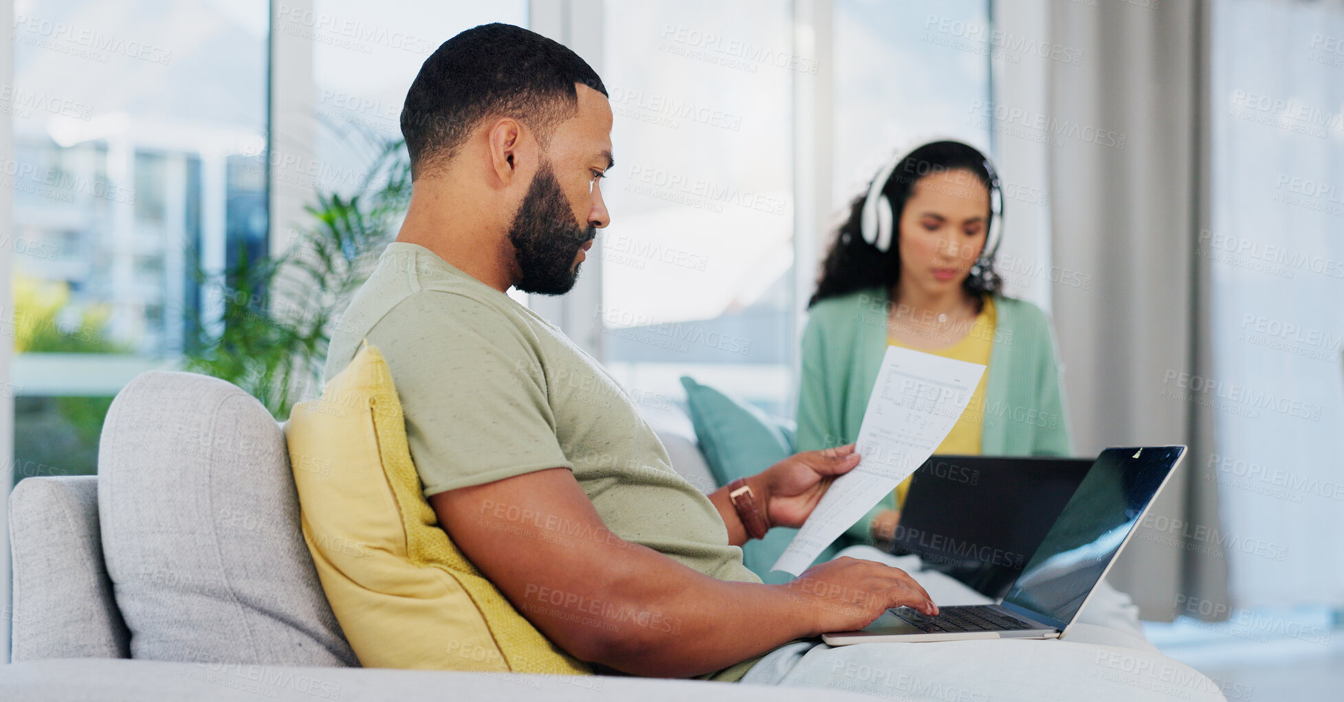 Buy stock photo Man, finance and page with laptop on sofa for financial planning, budget or invoice at home. Young male person, couple and expenses with bills on computer for mortgage, payment or inflation at house