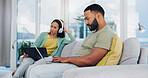 Couple, relax and busy with laptop on sofa for personal business, communication or network at home. Young, man and woman with technology on couch for online connectivity, social media or browsing