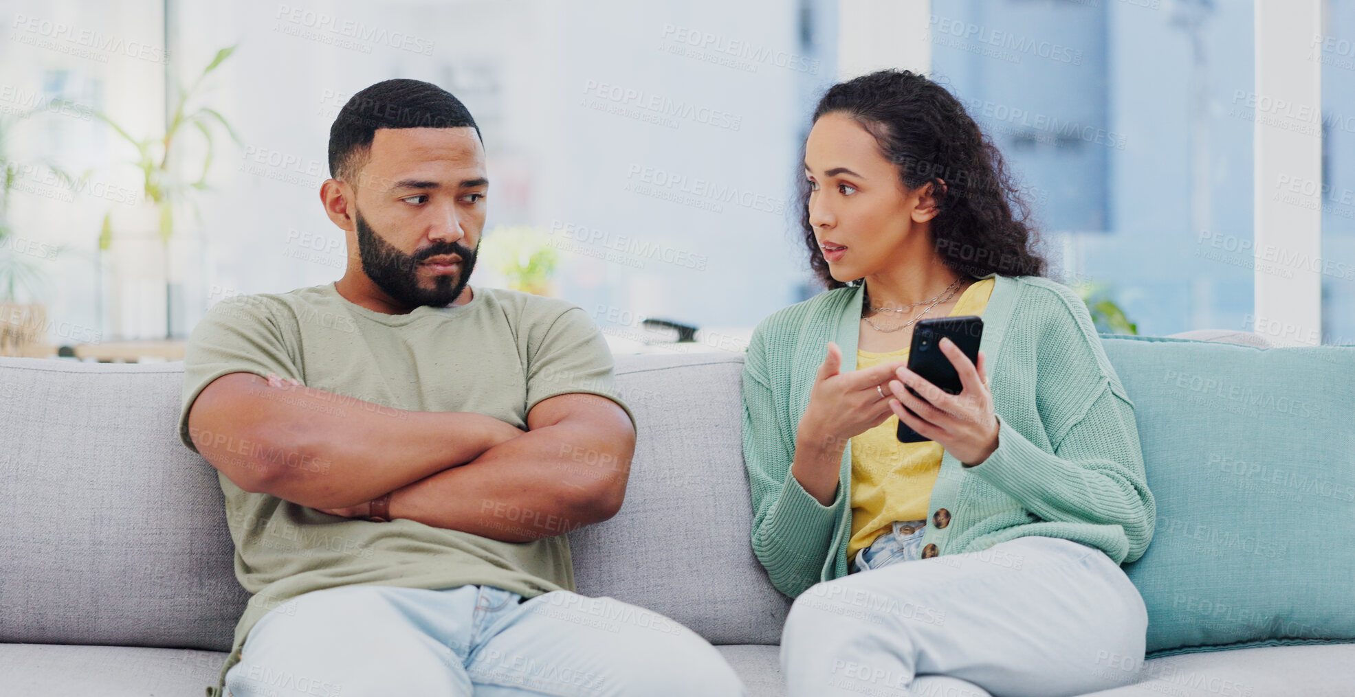 Buy stock photo Phone, cheating and couple with argument on sofa in living room for divorce, affair or breakup. Cellphone, upset and young man and woman fighting for text with online infidelity on dating app in home