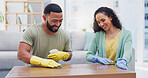 Couple, spray and sponge for table in home with smile for spring cleaning, shine or polish in living room. Man, woman and happy for teamwork, bonding and gloves for hygiene, bacteria or wood in house