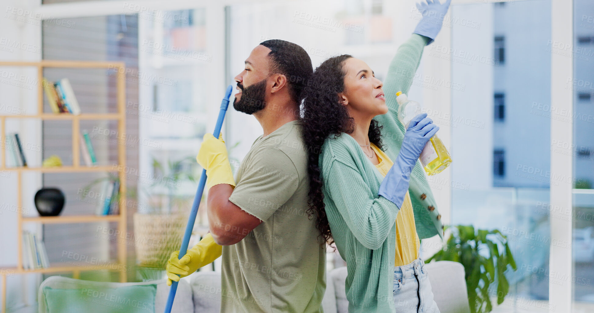 Buy stock photo Couple, singing and happy for cleaning in home with bottle, mop or microphone for funny game in morning. Man, woman and playful for karaoke, bonding and gloves for hygiene, bacteria and joke in house