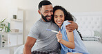 Couple, pregnancy stick and excited for results in home, hug and support for positive baby news. People, plastic test and happy for reading ovulation tool in bedroom, fertility treatment and embrace