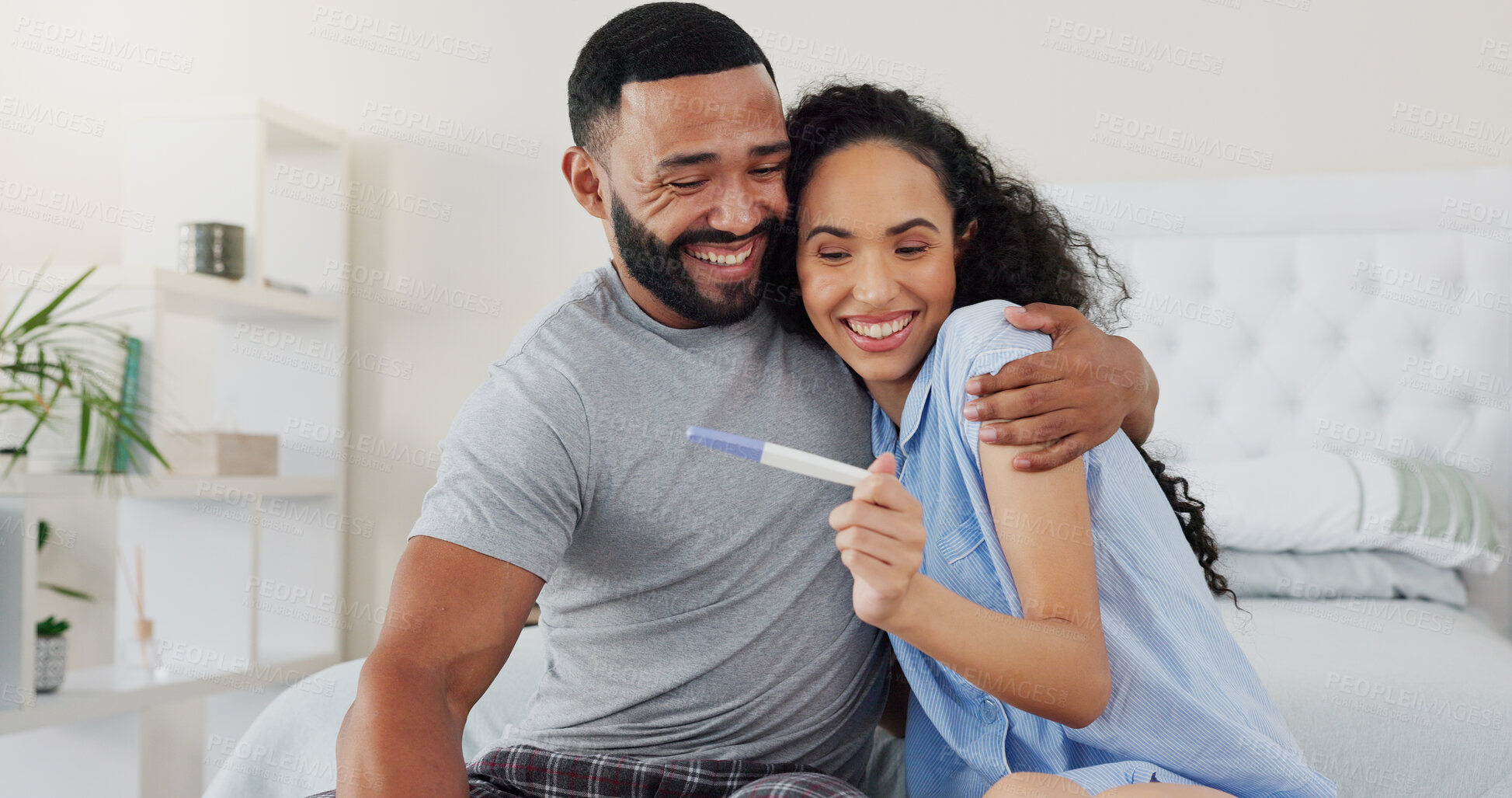 Buy stock photo Couple, pregnancy stick and excited for results in home, hug and support for positive baby news. People, plastic test and happy for reading ovulation tool in bedroom, fertility treatment and embrace