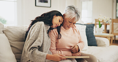 Buy stock photo Women, senior mother and sad with photo frame, hug and empathy for grief, memory and love in lounge. Family, people and embrace with support, trust and comfort in house for depression in retirement