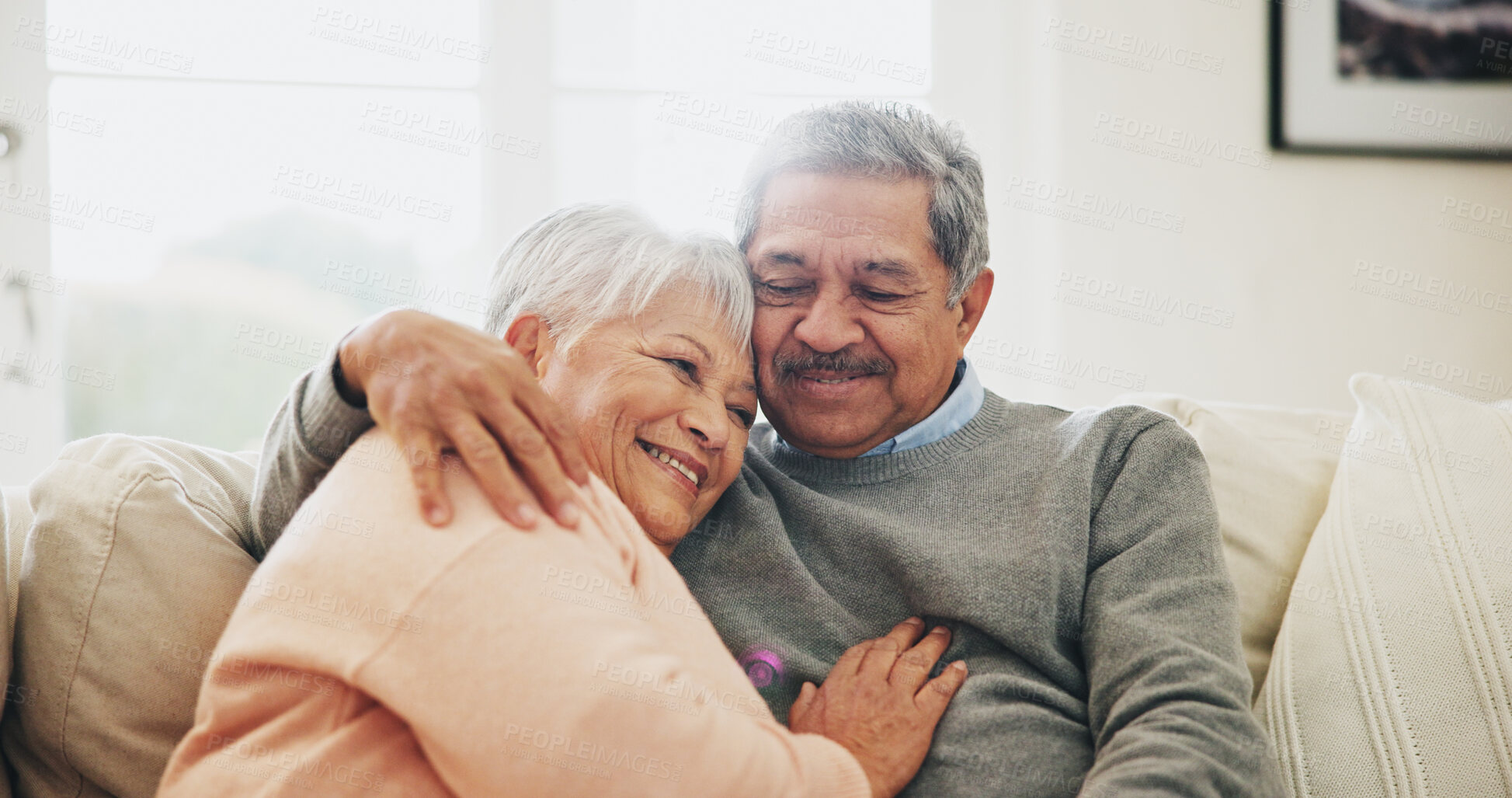 Buy stock photo Hug, relax and senior couple in house, love and care with retirement, happiness and bonding together. Apartment, embrace and mature woman with elderly man on sofa, support and comfortable in lounge