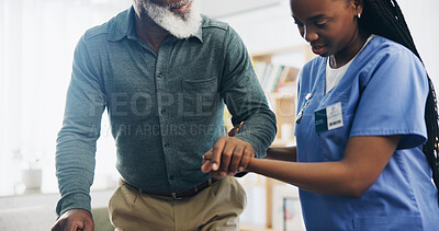 Buy stock photo Nurse, senior man and walking in home with help, care and support for recovery from injury in retirement. Black people, holding hands and elderly person with disability, caregiver and rehabilitation