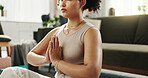 Home, meditation and woman with hand together, yoga and healthy girl with routine, calm and spiritual in lounge. Apartment, yogi and person with fitness, chakra or lotus for wellness, zen or training