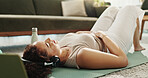 Woman, home and headphones for fitness on floor for exercise, workout and training with audio. Female person, living room and smile with music on mat for health, wellbeing and self care