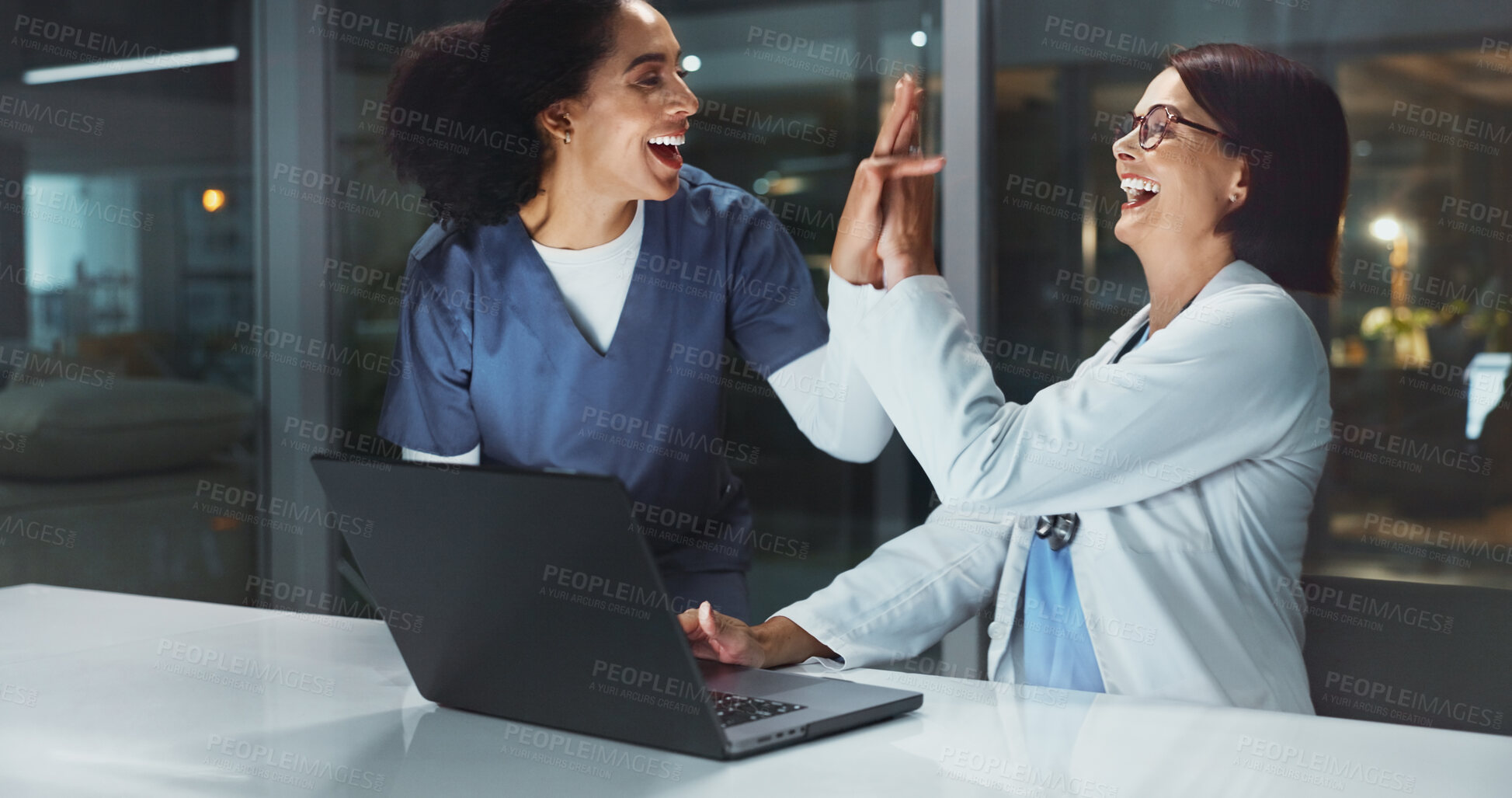 Buy stock photo Night, doctor and nurse on laptop high five for good news, goals or teamwork achievement in hospital. Medical results, overtime or happy woman on technology for mpox cure discovery or health success