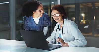 Buy stock photo Night, doctor and happy assistant on laptop for reading online for good news or schedule in hospital on digital app. Medical results, overtime or women with technology, clinic website or telehealth