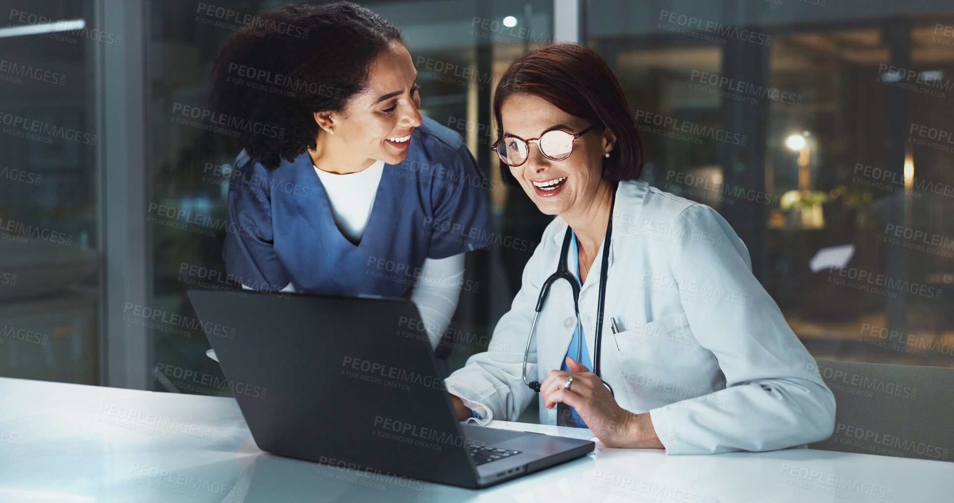 Buy stock photo Night, doctor and happy assistant on laptop for reading online for good news or schedule in hospital on digital app. Medical results, overtime or women with technology, clinic website or telehealth