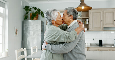 Buy stock photo Senior, man and woman with kiss, love and bonding together with romance in home kitchen. Elderly couple, married and happy in retirement with affection, relationship and support for trust in house