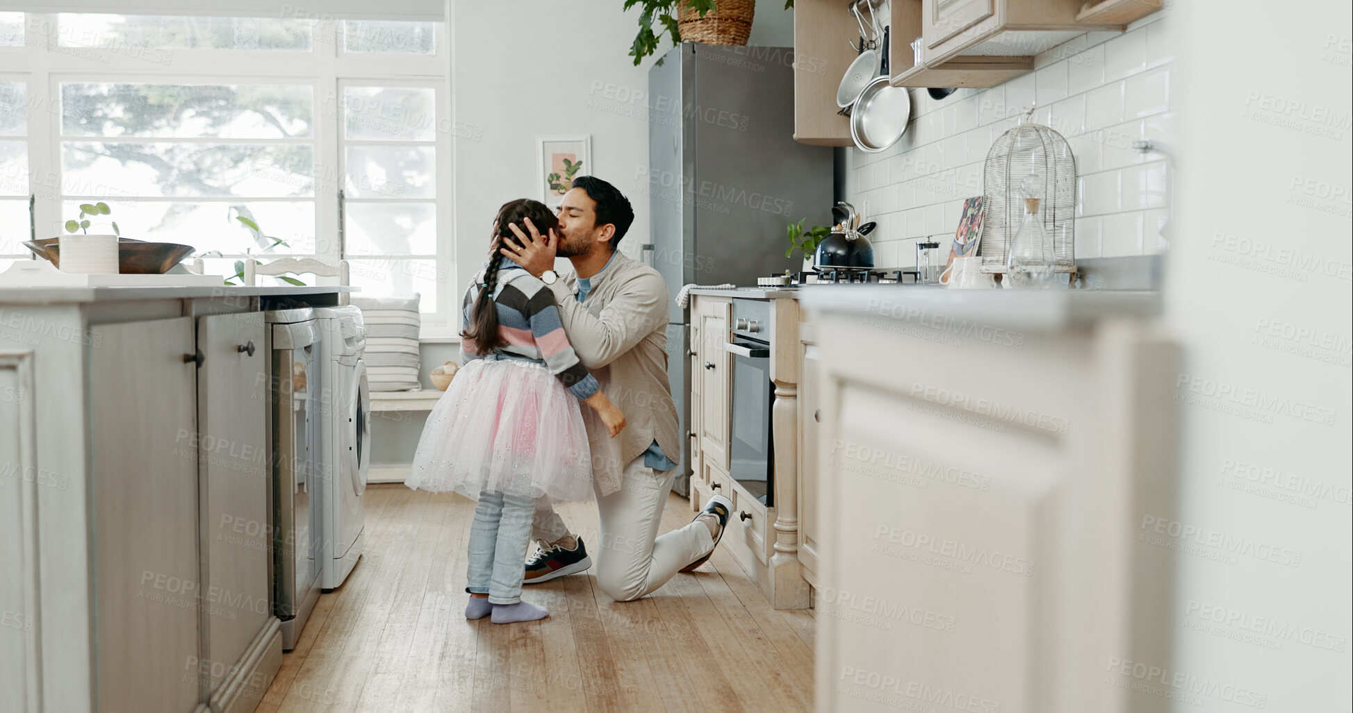 Buy stock photo Father, love and daughter with kiss on forehead in kitchen for support, care or bonding together at home. Dad, child or little girl with tutu of princess for dance, cosplay or affection at house