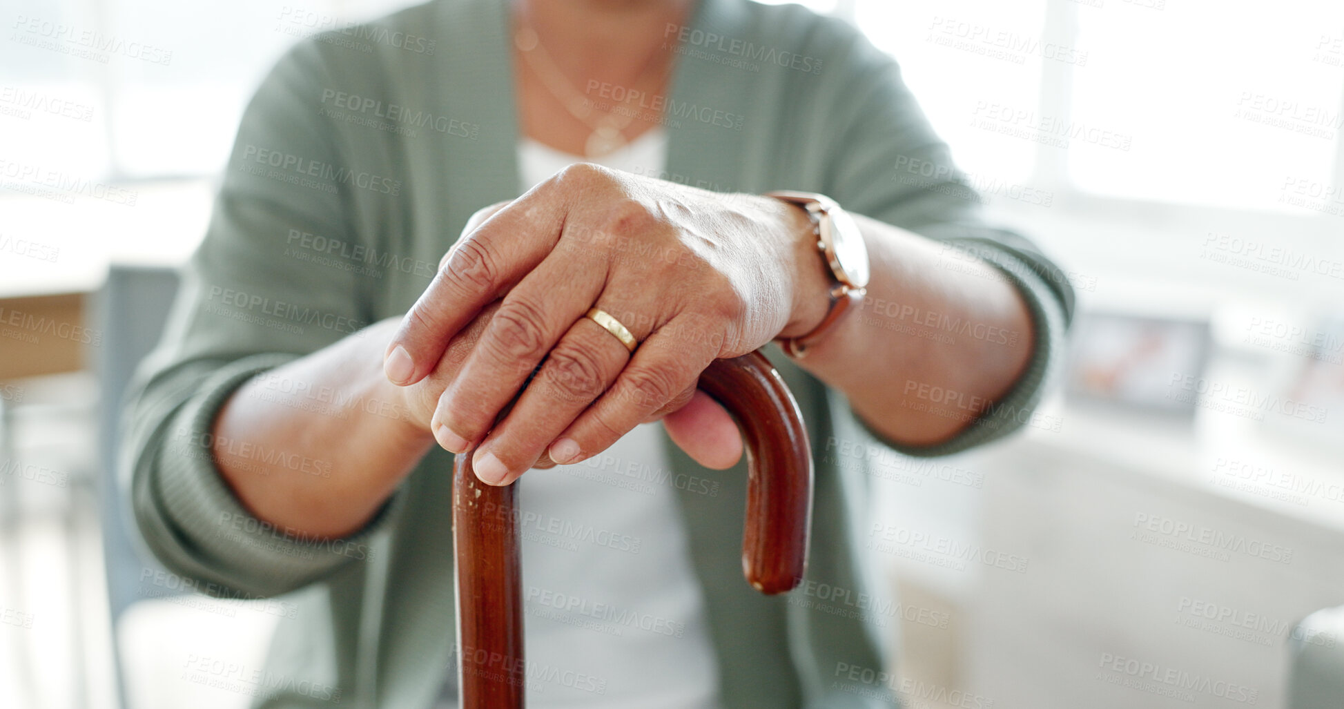 Buy stock photo Hands, senior and walking stick for support, health and mobility aid in retirement home. Closeup, cane and person with disability, injury and crutch to help with osteoporosis or arthritis in lounge