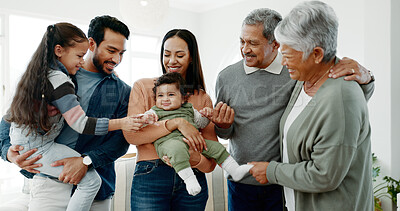 Buy stock photo Big family, love and playing with baby in home for weekend visit, bonding together and support. Happy people, parents and grandparents with children for fun holiday, playful and generations in house