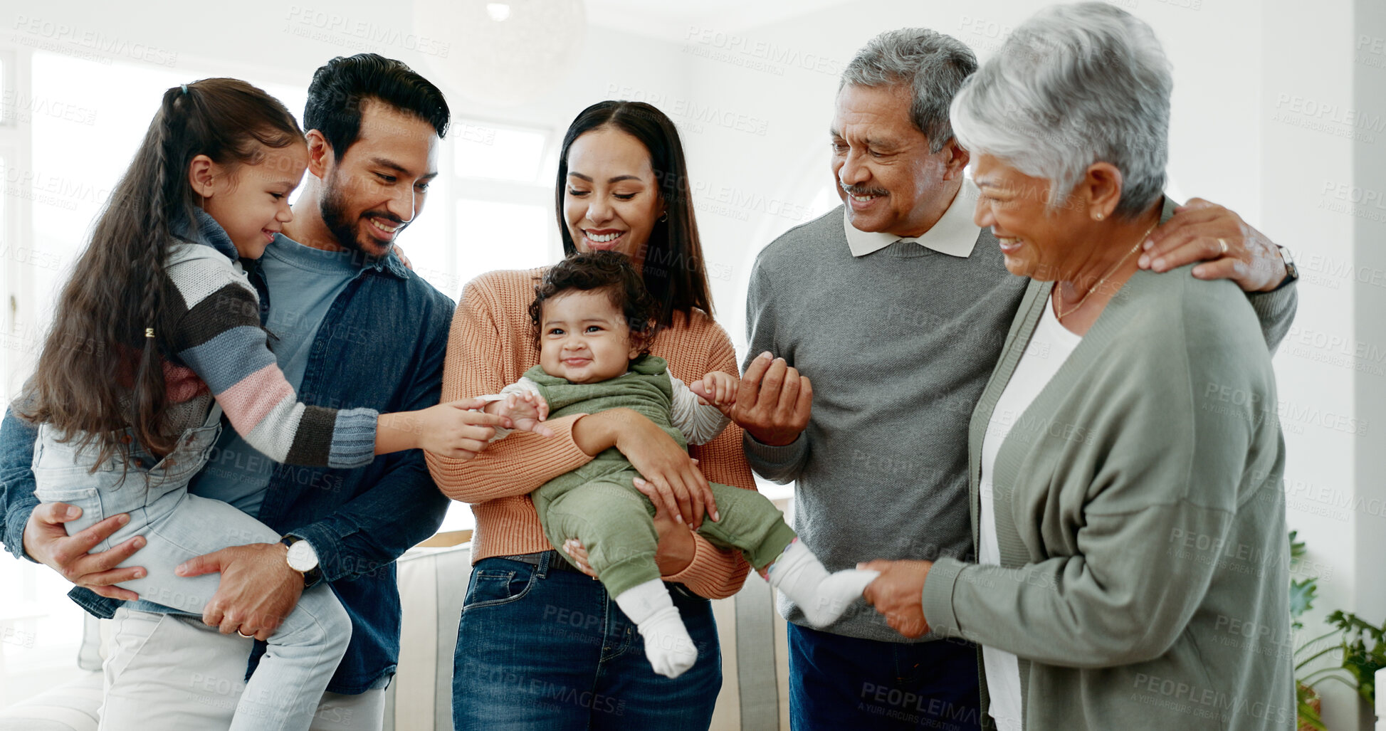 Buy stock photo Big family, love and playing with baby in home for weekend visit, bonding together and support. Happy people, parents and grandparents with children for fun holiday, playful and generations in house