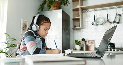 Buy stock photo Kitchen, child and homework with laptop for education, elearning and connection for online class. Girl, studying and cognitive development with writing for learner, knowledge and headphones at home