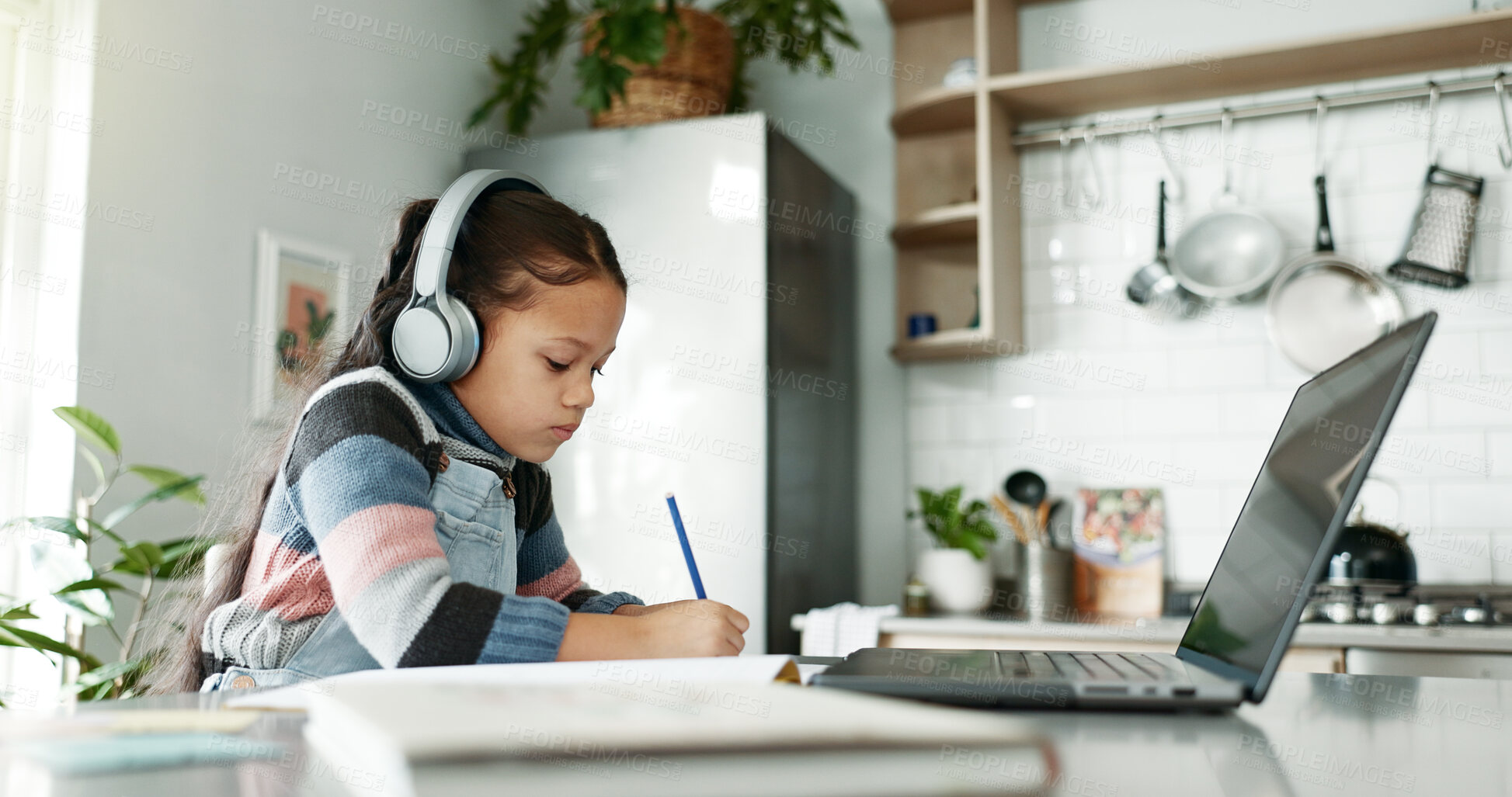 Buy stock photo Kitchen, child and homework with laptop for education, elearning and connection for online class. Girl, studying and cognitive development with writing for learner, knowledge and headphones at home