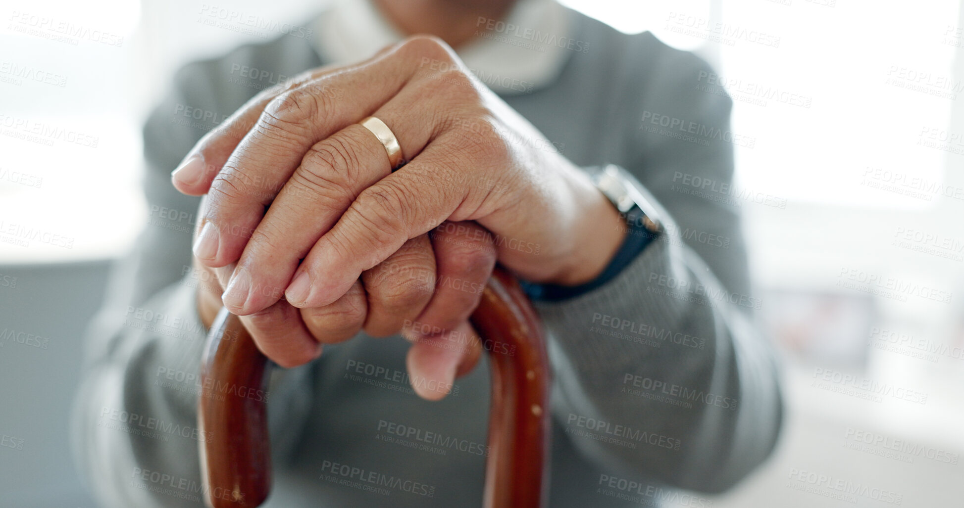 Buy stock photo Hands, walking stick and person in home for recovery, balance and aid for mobility in retirement. Wooden cane, injury or stroke with rehabilitation process for healing, wellness and health in house