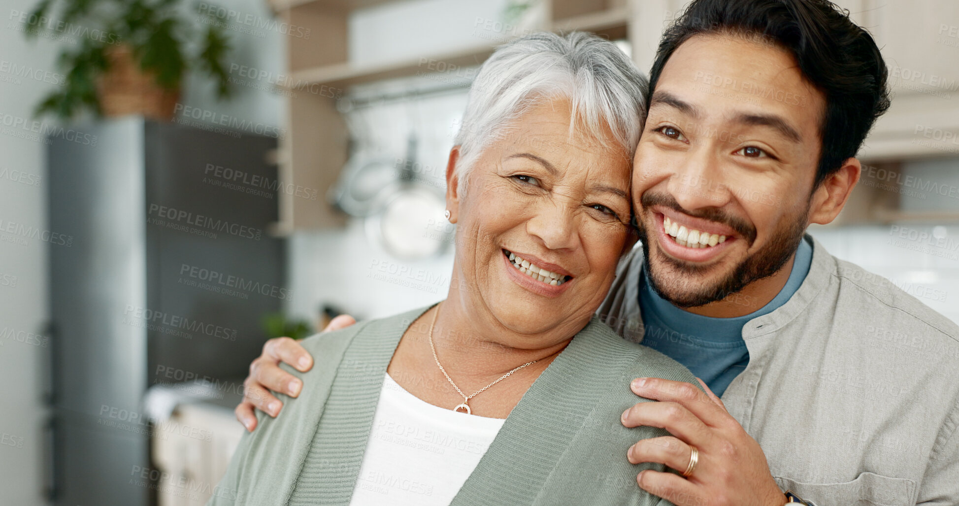 Buy stock photo Home, senior mother and son with hug for love, comfort and assurance with bonding together in kitchen. Happy people, elderly mom and man with embrace for mothers day, support and expression of care