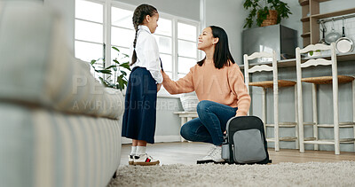 Buy stock photo Backpack, dressing and mom with child in home getting ready for education, learning and classes. Family, morning routine and happy mother with girl prepare with tie, uniform and clothes for school