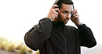 Thinking, headphones and man with training, outdoor and listening to podcast, breathing and sound. Runner, athlete and person with headset, nature and fitness with wellness, motivation and exercise