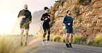 Fitness, running and training with friends in mountains together for cardio challenge or performance. Exercise, sports or workout with athlete men and woman on asphalt road in nature for improvement